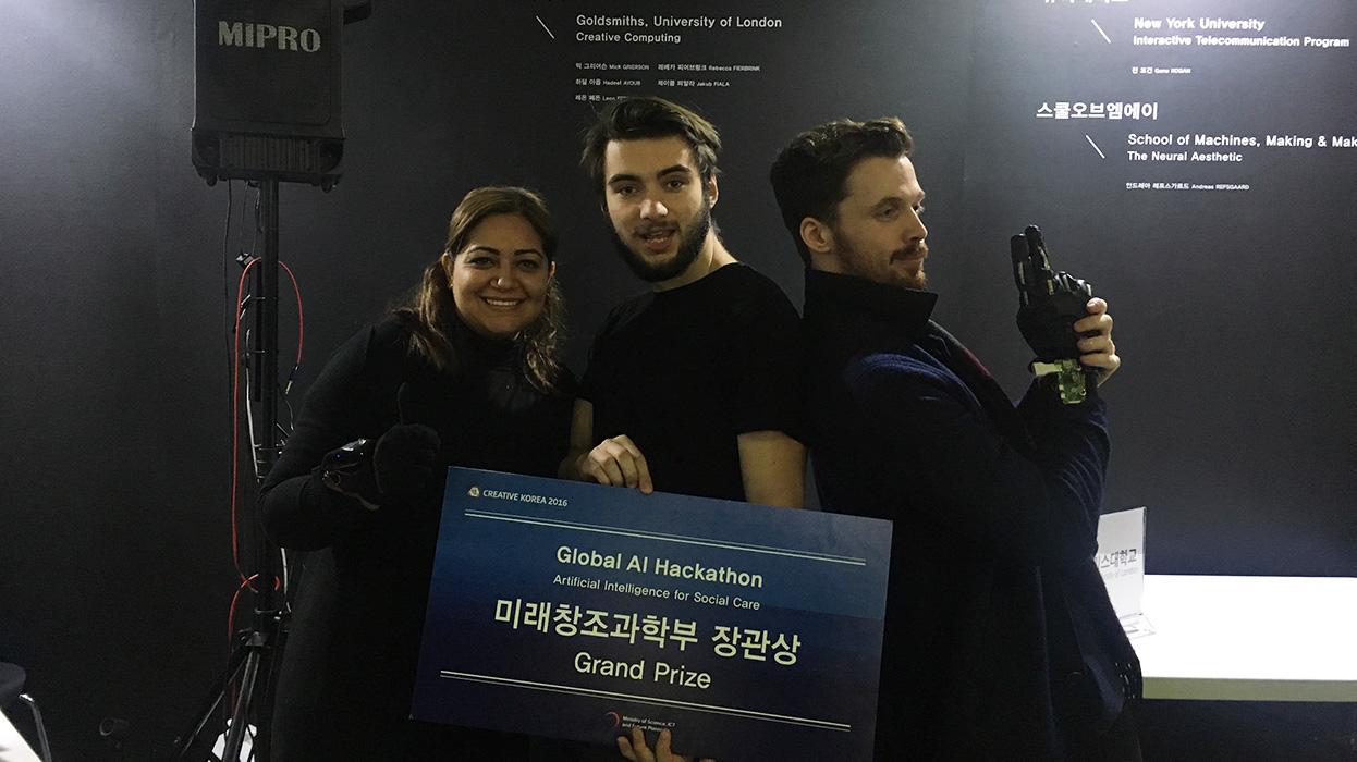Hadeel Ayoub, Jakub Fiala and Leon Fedden posing with the Global AI Hackathon award