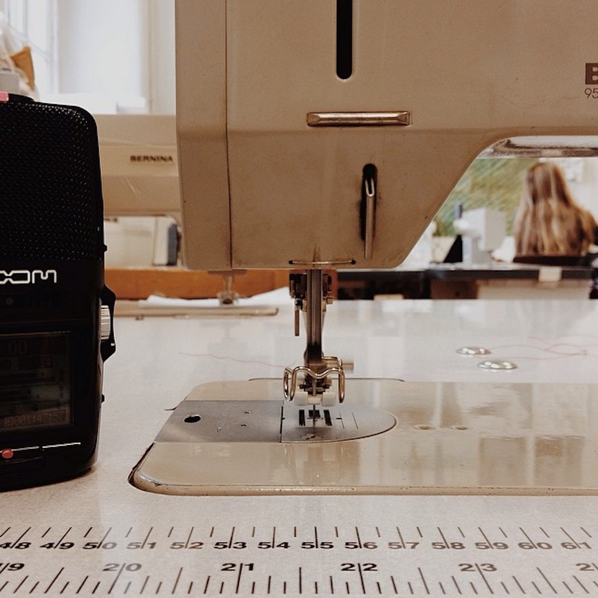 A Zoom recorder next to a sewing machine